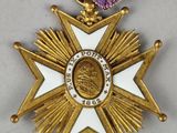 a close up of a medal with a purple ribbon around it