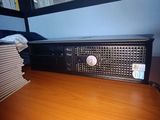an image of a computer on a desk with a stack of books