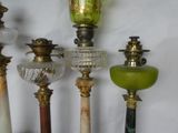 a lot of different colored glass lamps on a table