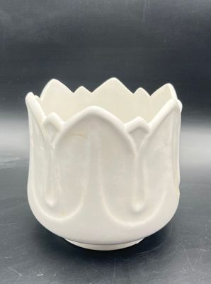 a close up of a white bowl on a table