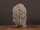 a close up of a statue of a head on a wooden table