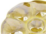 a close up of a yellow glass object on a white surface
