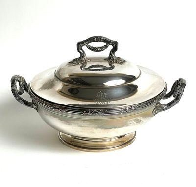 a silver bowl with a handle on top of it