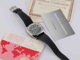 a watch that is sitting on a table next to some cards