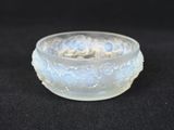 a glass bowl that is sitting on a black surface