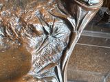 a bronze statue of a man and a woman sitting on a bench