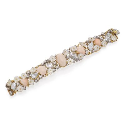 a close up of a hair clip with pearls and stones