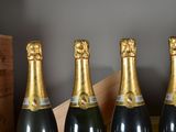 four bottles of champagne are lined up in a row on a table