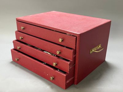a small red box with three drawers on it