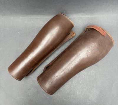pair of brown leather boots with brown leather linings on a gray surface