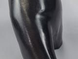 a black sculpture of a bear on a white surface