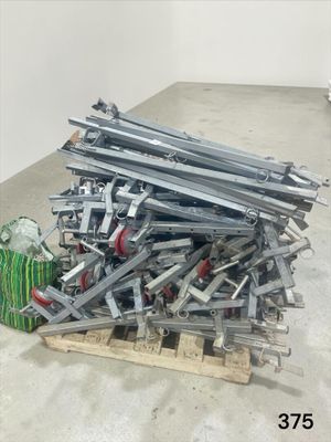 a pile of metal items on a pallet in a room