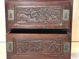 two wooden drawers with carvings on them on a table