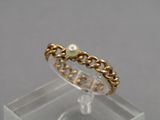 a close up of a gold ring with a pearl on it
