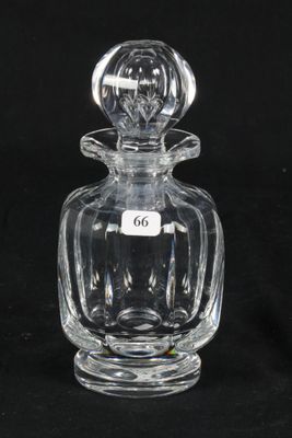 an old fashioned glass perfume bottle with a label on it