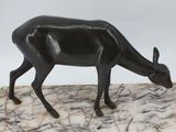 statue of a deer on a marble base with a white background