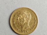 a close up of a gold coin on a white surface