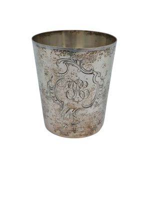 an old silver cup with a decorative design on it