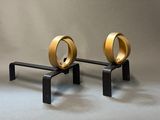 two gold rings on a black stand on a gray background