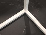 a toilet in a bathroom with a black floor and a black wall