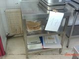 a small table with a sandwich on it in a kitchen