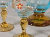 four wine glasses sitting on a table next to each other