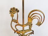 a gold colored candle holder with a rooster on it