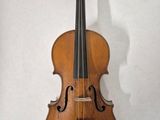 an old violin hanging on a wall in a room