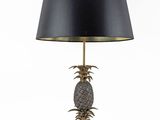 a close up of a lamp on a table with a black shade