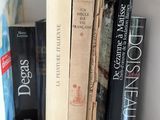 many books that are on a shelf in a room