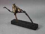 statue of a bird perched on a branch on a marble base