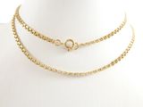 a close up of a gold necklace on a mannequin mannequin