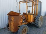 a rusted tractor parked in front of a building