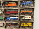 many different types of toy trucks in a display case