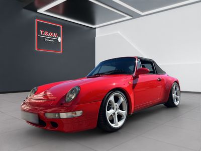 the red porsche 993 is parked in a garage