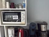many different appliances on the counter in this kitchen