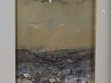 painting of a landscape in a gold frame on a white wall