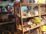 a wooden shelf filled with lots of items in a room