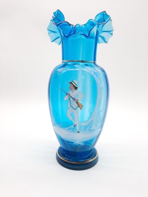 a blue glass vase with a picture of a man on it