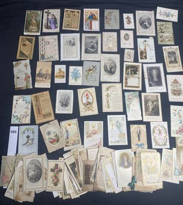 a lot of old postcards on a black table
