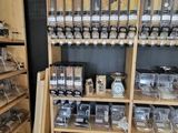 a shelf full of jars and containers in a store
