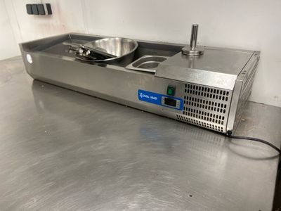 stainless steel counter top with a frying pan and a frying pan on it