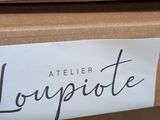 a sign that says atelier louprite on the side of a box