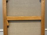 an old picture frame with a picture hanging on the wall
