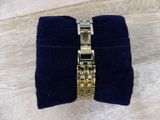 a close up of a watch on a velvet case on a wooden surface