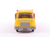 a yellow toy truck that is on a white surface