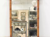 a mirror that is sitting on a shelf in a room