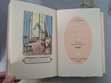 someone is holding a book with a picture of a woman in a pink dress