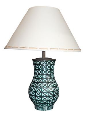 a lamp that is sitting on a table with a shade on it
