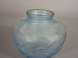 a blue glass vase that is sitting on a table
